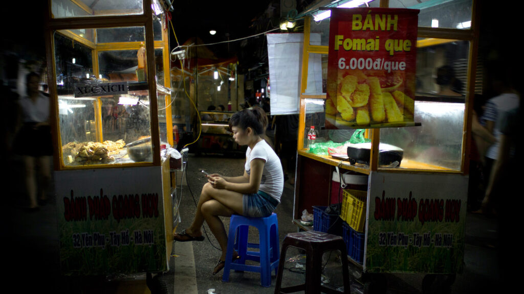 A woman uses a smartphone in Hanoi, Vietnam, in 2013. (Nathan O’Nions/Flickr)