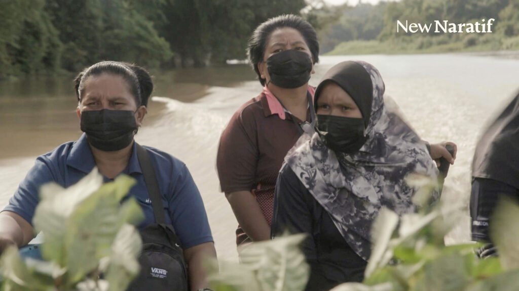 Women from Sabah’s Sukau Village ride in a boat before working to replant forests in the Kinabatangan River region in late 2021. Chen Yih Wen